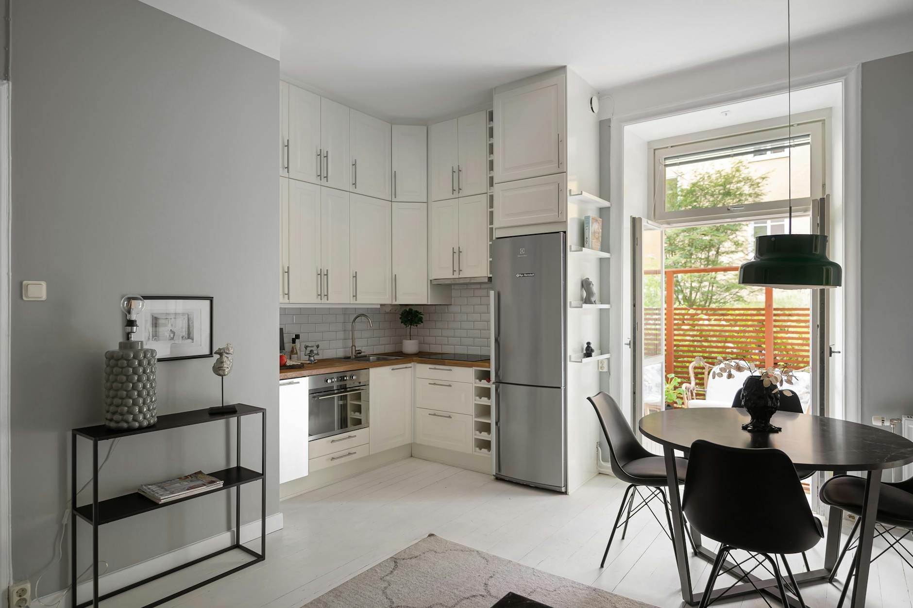 modern interior with white cupboards and black chairs