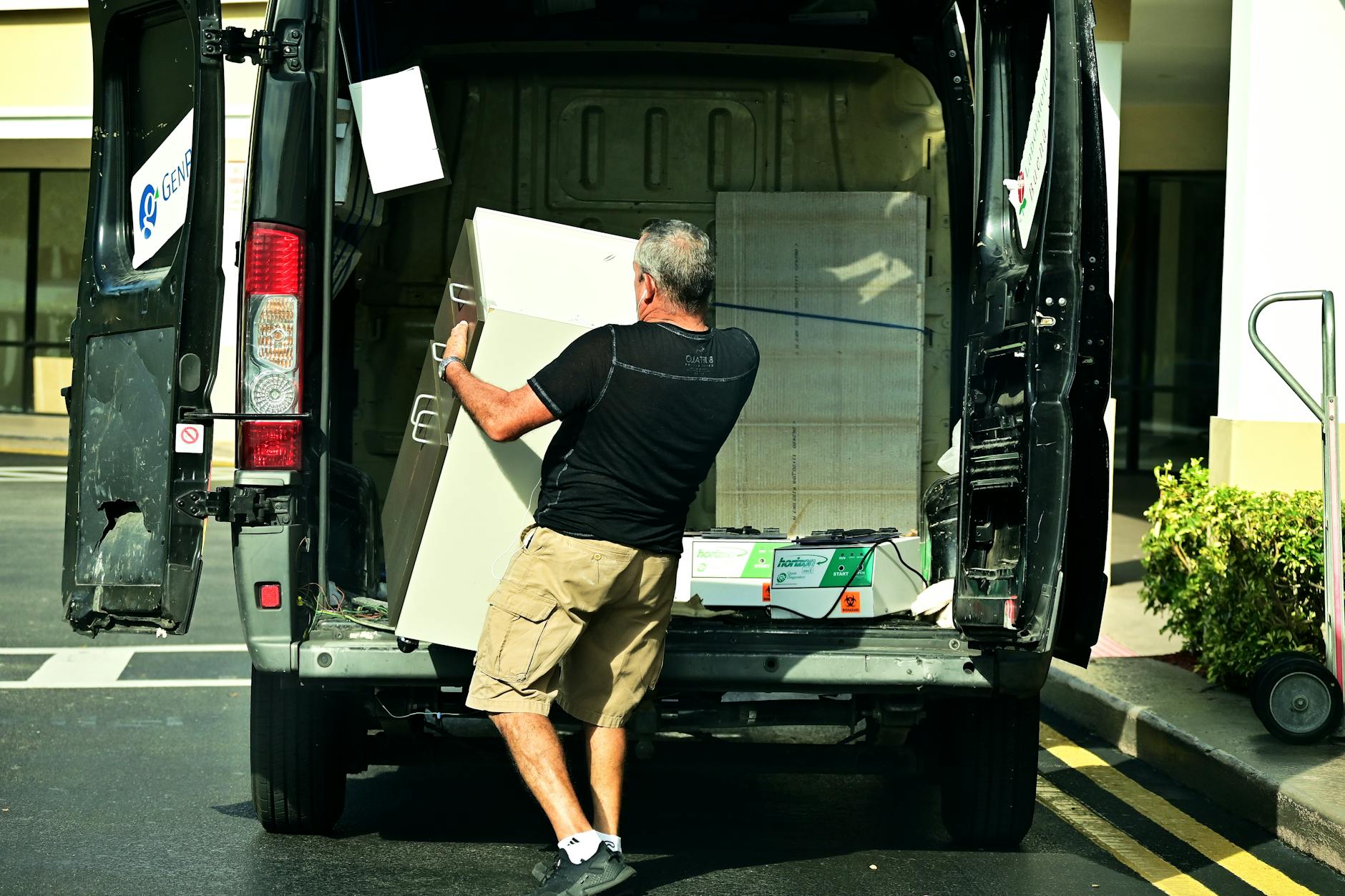 a man delivering a cabinet from the van